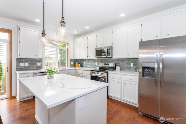 14808 26th Pl W Unit 2, Lynnwood, WA 98087 - kitchen featuring appliances with stainless steel finishes, white cabinetry, dark wood-type flooring, decorative backsplash, and decorative light fixtures
