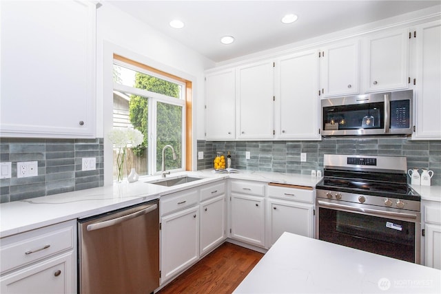 14808 26th Pl W Unit 2, Lynnwood, WA 98087 - kitchen featuring appliances with stainless steel finishes, white cabinetry, tasteful backsplash, dark wood-style floors, and recessed lighting