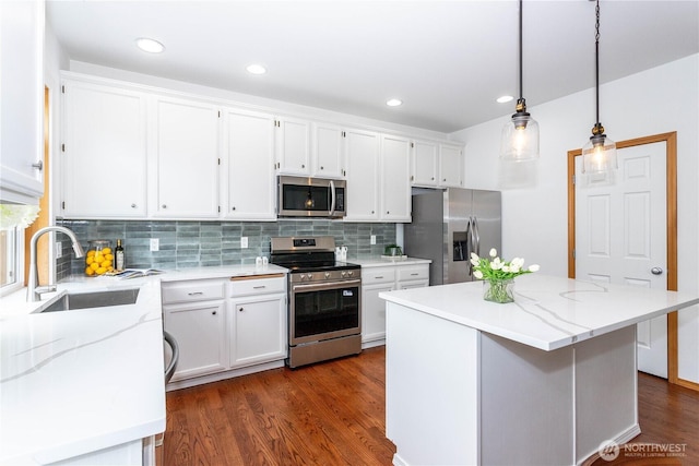 14808 26th Pl W Unit 2, Lynnwood, WA 98087 - kitchen featuring stainless steel appliances, white cabinetry, decorative backsplash, dark wood finished floors, and recessed lighting