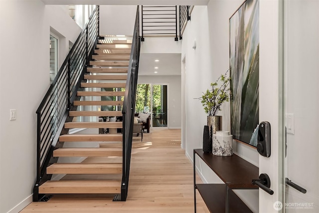 13321 108th Ave NE, Kirkland, WA 98034 - stairs with a high ceiling, baseboards, and wood finished floors