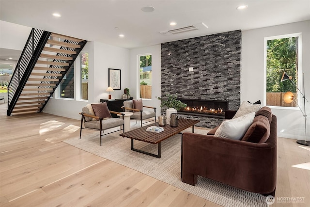 13321 108th Ave NE, Kirkland, WA 98034 - living room featuring wood finished floors, stairway, a stone fireplace, recessed lighting, and plenty of natural light
