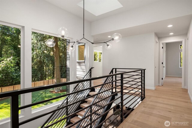 13321 108th Ave NE, Kirkland, WA 98034 - hallway featuring an upstairs landing, light wood finished floors, a skylight, recessed lighting, and baseboards