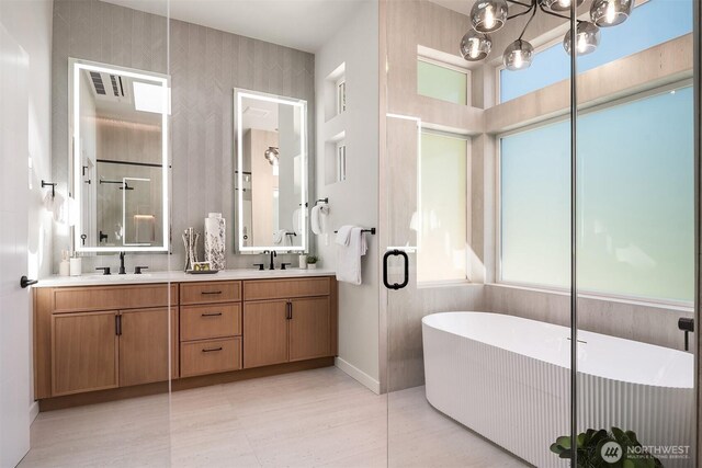 13321 108th Ave NE, Kirkland, WA 98034 - bathroom with a freestanding tub, double vanity, baseboards, and a chandelier