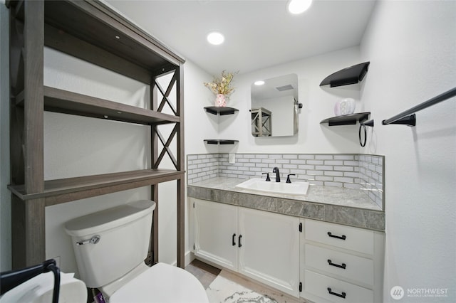 513 SE Highland Park Dr, College Place, WA 99324 - half bathroom with vanity, toilet, decorative backsplash, and recessed lighting
