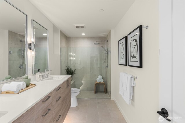 112F 2nd St S, Kirkland, WA 98033 - bathroom featuring tile patterned floors, double vanity, toilet, and tiled shower