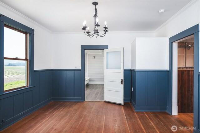 19719 Dry Slough Rd, Mount Vernon, WA 98273 - unfurnished dining area featuring a chandelier, a wainscoted wall, hardwood / wood-style floors, and crown molding