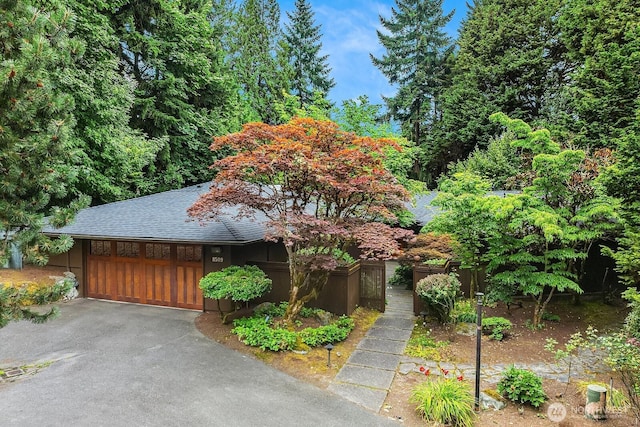 8509 NE 27th Pl, Clyde Hill, WA 98004 - view of front of property with asphalt driveway, an attached garage, and roof with shingles