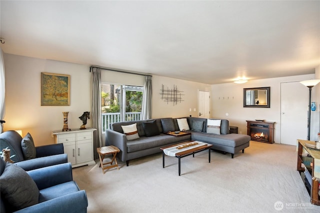 70 E Rustle Way, Grapeview, WA 98546 - living room with light carpet and a warm lit fireplace