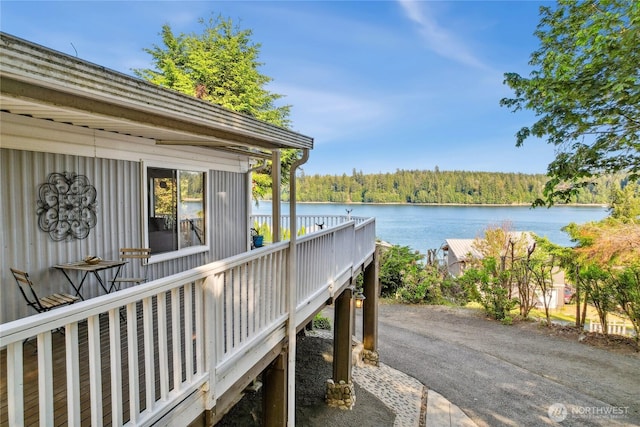 70 E Rustle Way, Grapeview, WA 98546 - deck featuring a water view and a wooded view