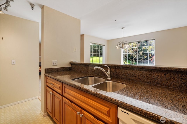7453 Newcastle Golf Club Rd Unit B103, Newcastle, WA 98059 - kitchen with a sink, brown cabinetry, light flooring, and dark stone counters
