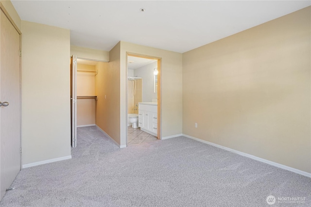 7453 Newcastle Golf Club Rd Unit B103, Newcastle, WA 98059 - unfurnished bedroom featuring light carpet, a closet, baseboards, and ensuite bath