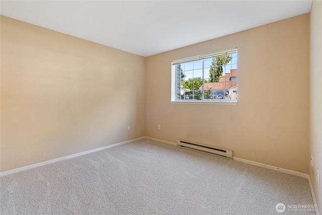 7453 Newcastle Golf Club Rd Unit B103, Newcastle, WA 98059 - empty room featuring a baseboard radiator, baseboards, and carpet flooring