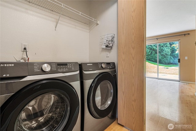 7453 Newcastle Golf Club Rd Unit B103, Newcastle, WA 98059 - washroom featuring washer and clothes dryer and light wood-type flooring