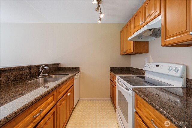 7453 Newcastle Golf Club Rd Unit B103, Newcastle, WA 98059 - kitchen with under cabinet range hood, white appliances, a sink, light flooring, and dark stone countertops