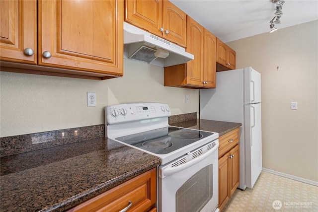 7453 Newcastle Golf Club Rd Unit B103, Newcastle, WA 98059 - kitchen featuring white appliances, under cabinet range hood, light floors, rail lighting, and brown cabinetry
