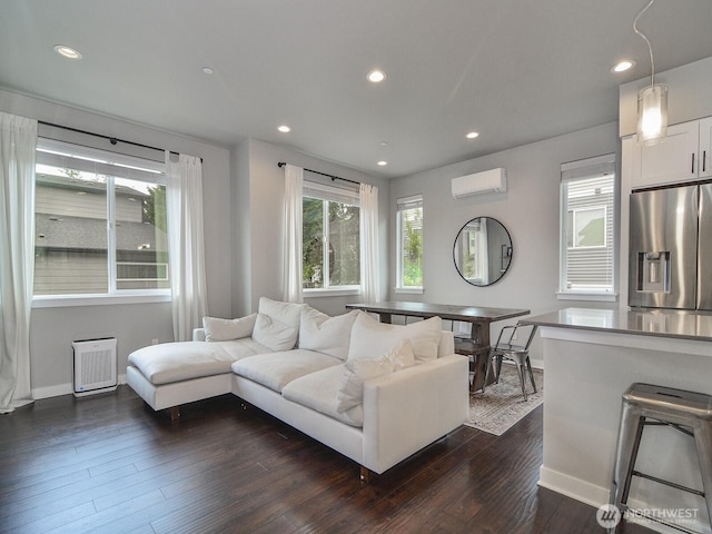 3230 148th St SW Unit C1, Lynnwood, WA 98087 - living room with a wall mounted air conditioner, dark wood finished floors, baseboards, and recessed lighting