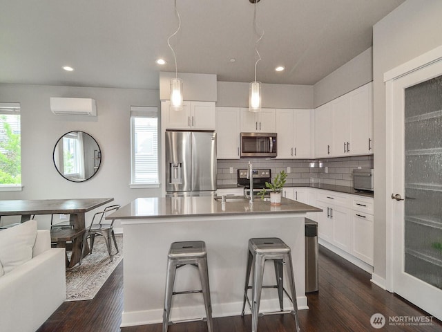 3230 148th St SW Unit C1, Lynnwood, WA 98087 - kitchen with stainless steel appliances, an AC wall unit, a sink, dark wood-style flooring, and tasteful backsplash