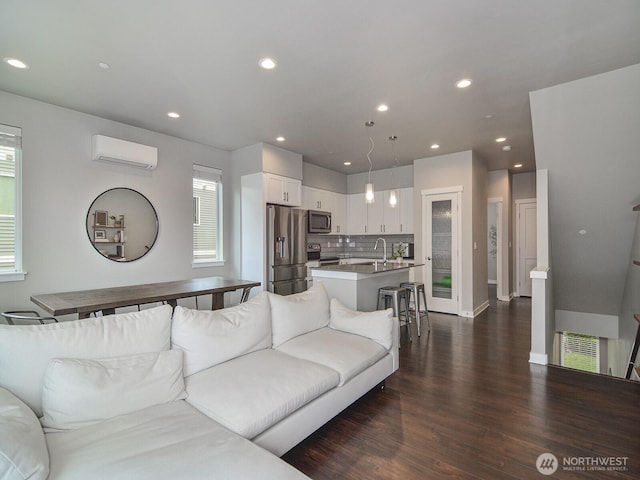 3230 148th St SW Unit C1, Lynnwood, WA 98087 - living area featuring dark wood finished floors, a wall unit AC, recessed lighting, healthy amount of natural light, and baseboards