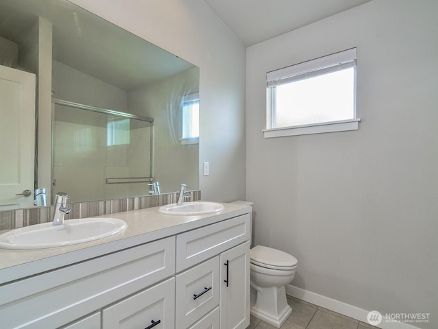 3230 148th St SW Unit C1, Lynnwood, WA 98087 - bathroom featuring toilet, double vanity, tile patterned floors, a shower with door, and baseboards