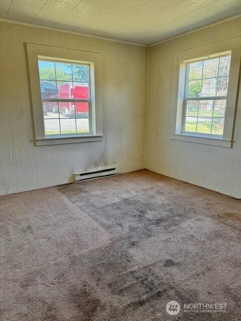 813 SW 3rd Ave, Castle Rock, WA 98611 - carpeted empty room featuring crown molding, baseboard heating, plenty of natural light, and a textured ceiling
