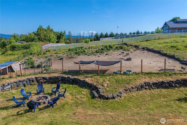 9906 328th St E, Graham, WA 98338 - view of play area featuring an outdoor fire pit and a view of rural / pastoral area