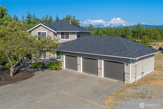 9906 328th St E, Graham, WA 98338 - view of front of home featuring an attached garage, asphalt driveway, and a shingled roof
