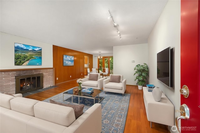 10210 NE 23rd St, Bellevue, WA 98004 - living room featuring wood finished floors, a fireplace, and rail lighting