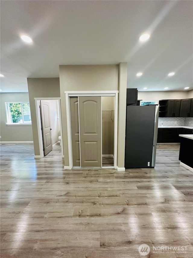 511 Baila Way, Aberdeen, WA 98520 - kitchen featuring freestanding refrigerator, light wood-style floors, dark cabinets, baseboards, and recessed lighting