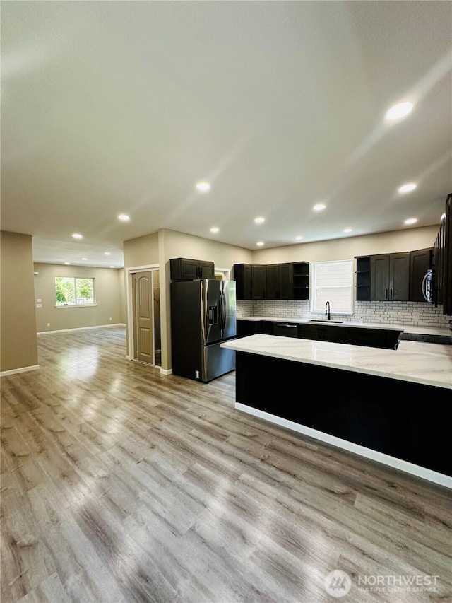 511 Baila Way, Aberdeen, WA 98520 - kitchen featuring stainless steel refrigerator with ice dispenser, a sink, open floor plan, recessed lighting, and decorative backsplash