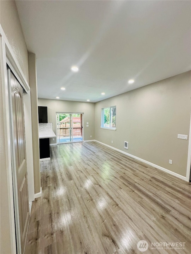 511 Baila Way, Aberdeen, WA 98520 - unfurnished living room featuring light wood-type flooring, baseboards, and recessed lighting
