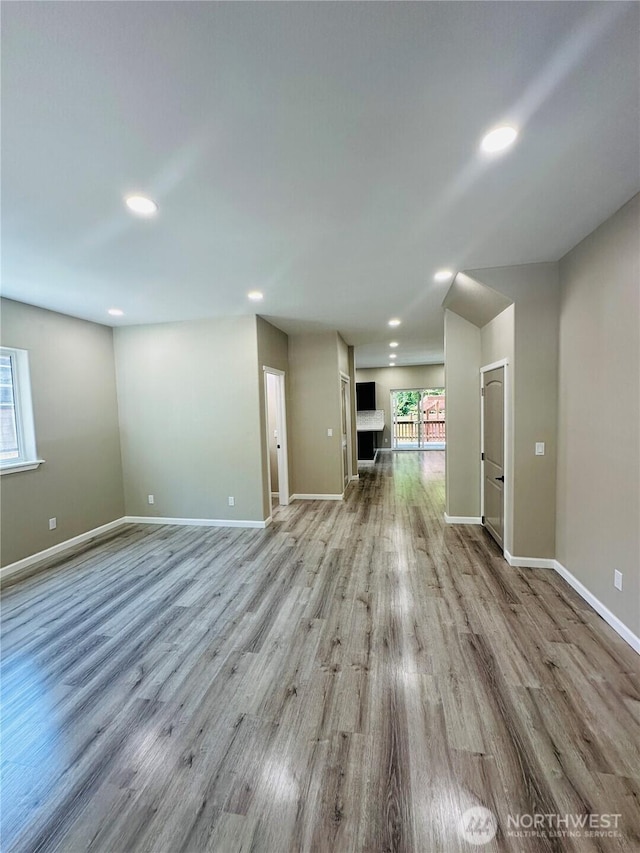 511 Baila Way, Aberdeen, WA 98520 - unfurnished living room featuring light wood-type flooring, baseboards, recessed lighting, and healthy amount of natural light