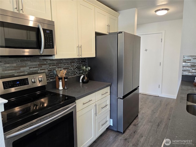 12700 NE 8th St Unit E308, Bellevue, WA 98005 - kitchen featuring appliances with stainless steel finishes, tasteful backsplash, dark wood-style floors, and white cabinetry