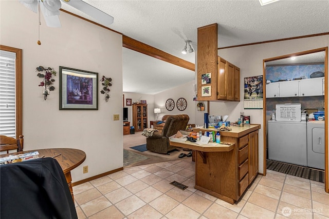 322 N Kentucky Unit A & B, East Wenatchee, WA 98802 - kitchen with independent washer and dryer, brown cabinetry, a ceiling fan, light tile patterned floors, and open floor plan