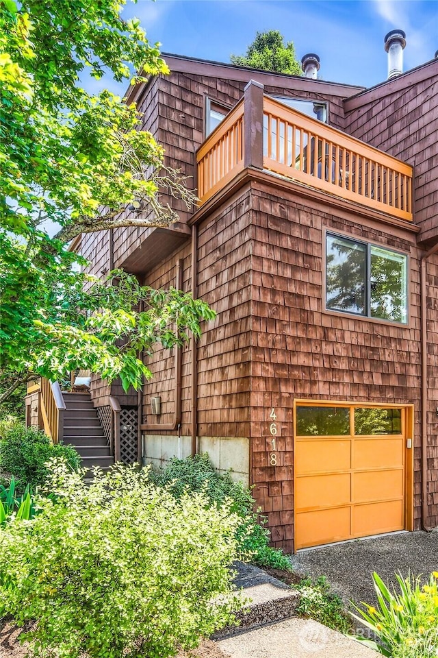4618 3rd Ave NW, Seattle, WA 98107 - view of side of property with a balcony, a garage, stairway, and gravel driveway
