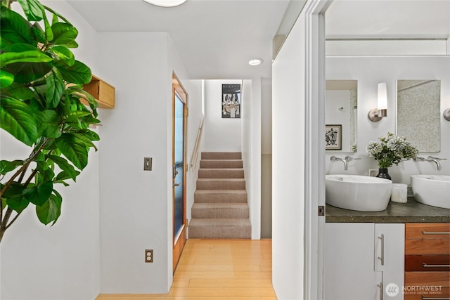 4618 3rd Ave NW, Seattle, WA 98107 - hallway with a sink, stairway, light wood-style flooring, and recessed lighting
