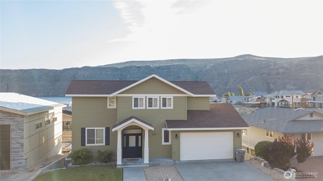 1071 S Section Pl, Quincy, WA 98848 - traditional home featuring a mountain view, concrete driveway, an attached garage, and roof with shingles