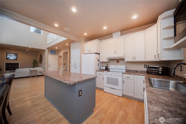 1071 S Section Pl, Quincy, WA 98848 - kitchen with white appliances, under cabinet range hood, a kitchen island, white cabinetry, and open floor plan