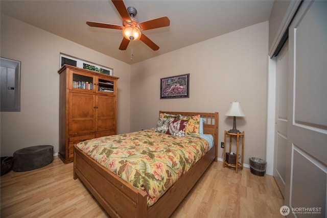 1071 S Section Pl, Quincy, WA 98848 - bedroom with light wood finished floors, electric panel, a closet, and a ceiling fan