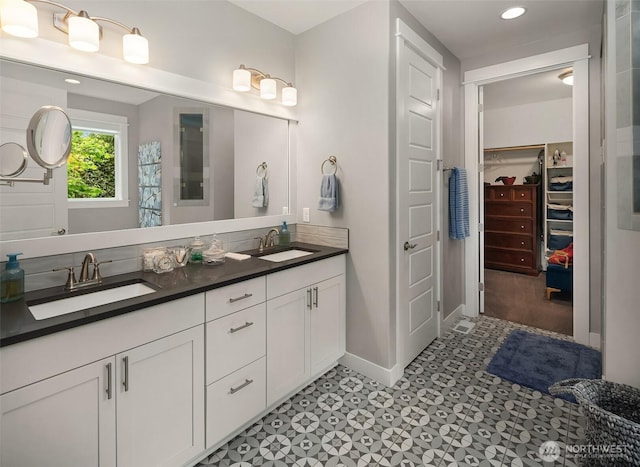 13039 56th Ave, Tukwila, WA 98178 - bathroom with double vanity, baseboards, a spacious closet, and recessed lighting