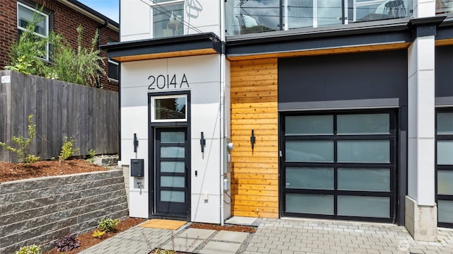 2014 E Pine St Unit A, Seattle, WA 98122 - view of exterior entry with a garage and stucco siding