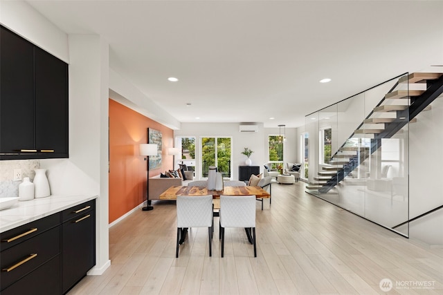 2014 E Pine St Unit A, Seattle, WA 98122 - dining room featuring a wall mounted air conditioner, stairs, recessed lighting, light wood-style floors, and baseboards