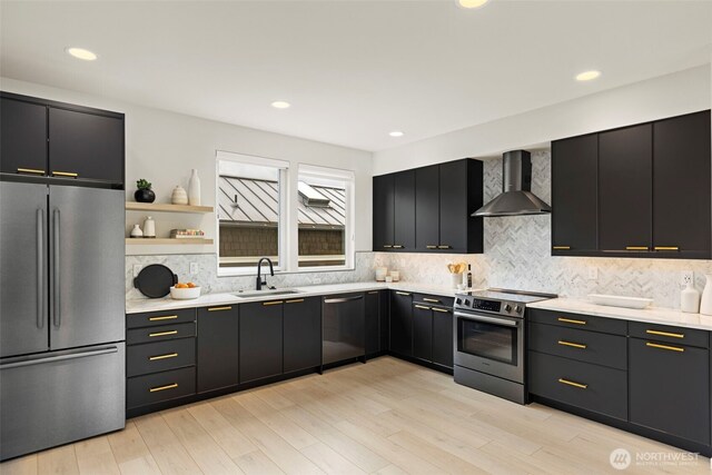 2014 E Pine St Unit A, Seattle, WA 98122 - kitchen featuring appliances with stainless steel finishes, wall chimney exhaust hood, a sink, light countertops, and recessed lighting
