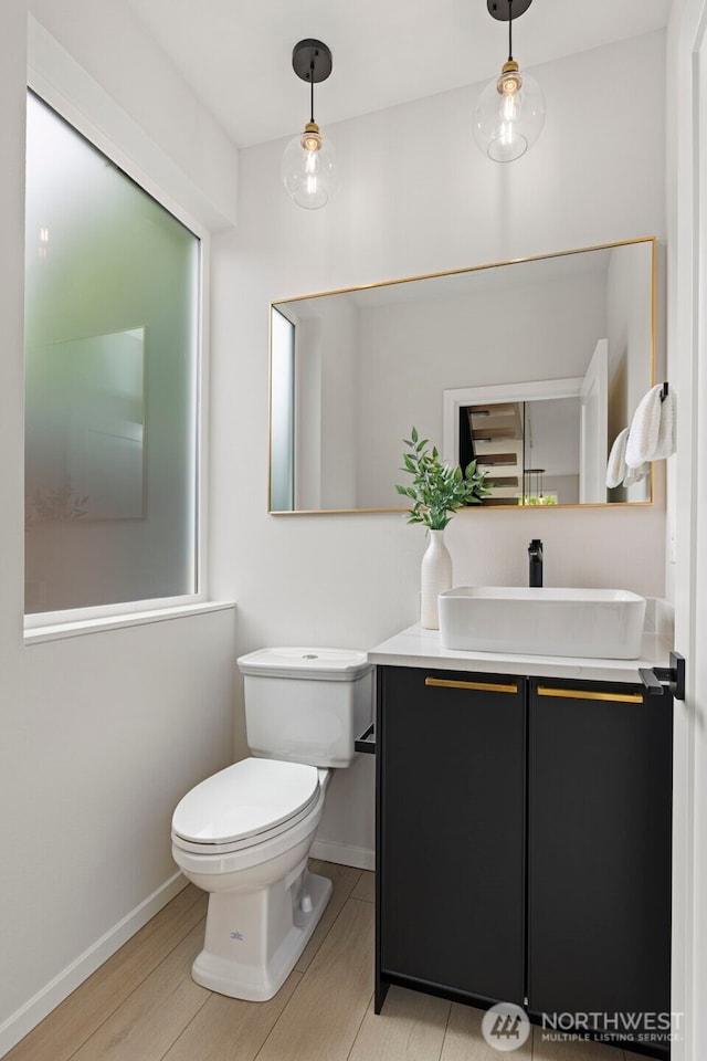 2014 E Pine St Unit A, Seattle, WA 98122 - half bathroom with toilet, vanity, wood finished floors, and baseboards