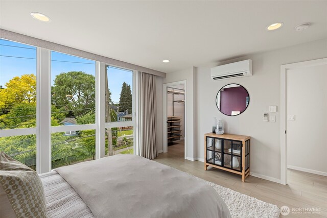 2014 E Pine St Unit A, Seattle, WA 98122 - bedroom with a wall mounted AC, multiple windows, a spacious closet, recessed lighting, and baseboards