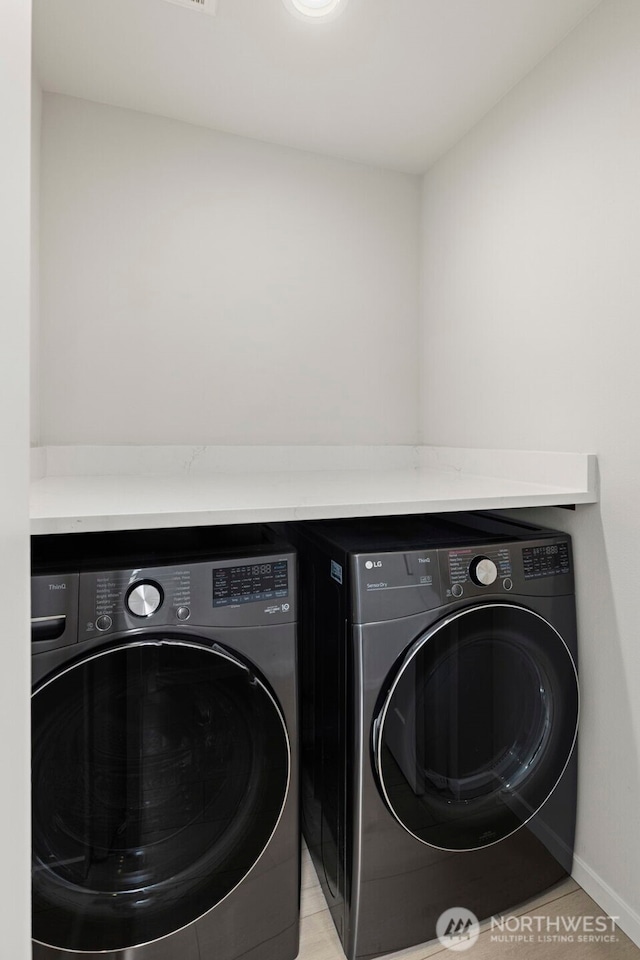 2014 E Pine St Unit A, Seattle, WA 98122 - laundry area with separate washer and dryer and baseboards