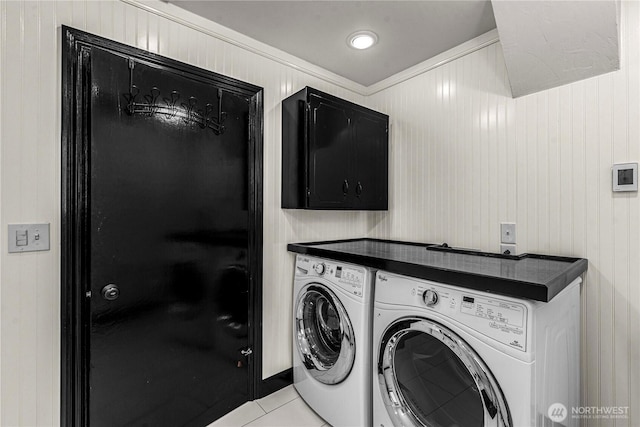 1108 Dale St SE, East Wenatchee, WA 98802 - laundry area with separate washer and dryer, light tile patterned floors, wood walls, and cabinet space
