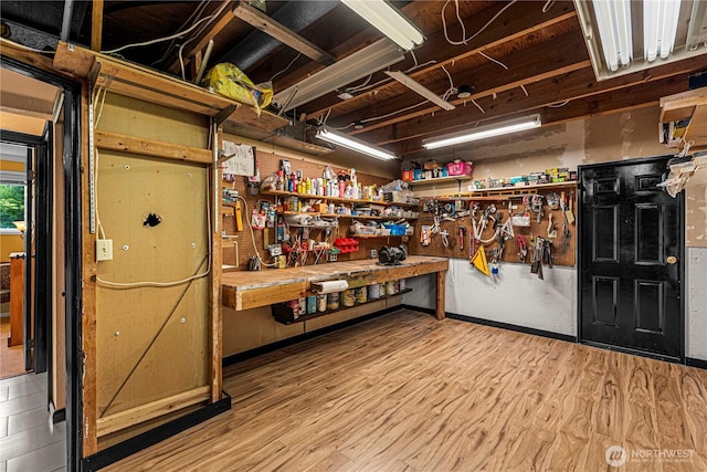 1108 Dale St SE, East Wenatchee, WA 98802 - miscellaneous room featuring a workshop area and wood finished floors