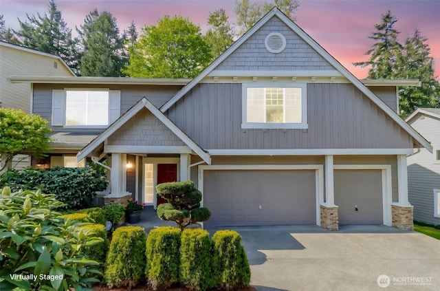 1913 NE 32nd St, Renton, WA 98056 - craftsman house featuring concrete driveway, an attached garage, board and batten siding, and stone siding
