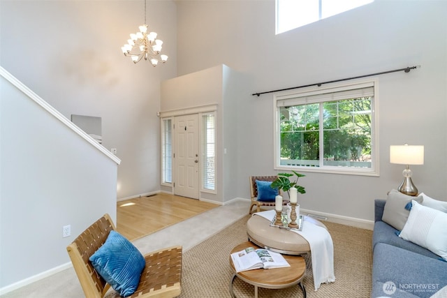 1913 NE 32nd St, Renton, WA 98056 - living area with a towering ceiling, a chandelier, carpet flooring, and baseboards