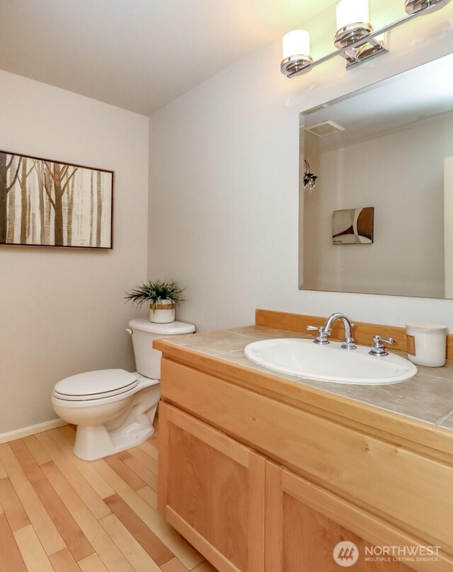 1913 NE 32nd St, Renton, WA 98056 - bathroom featuring toilet, vanity, and wood finished floors